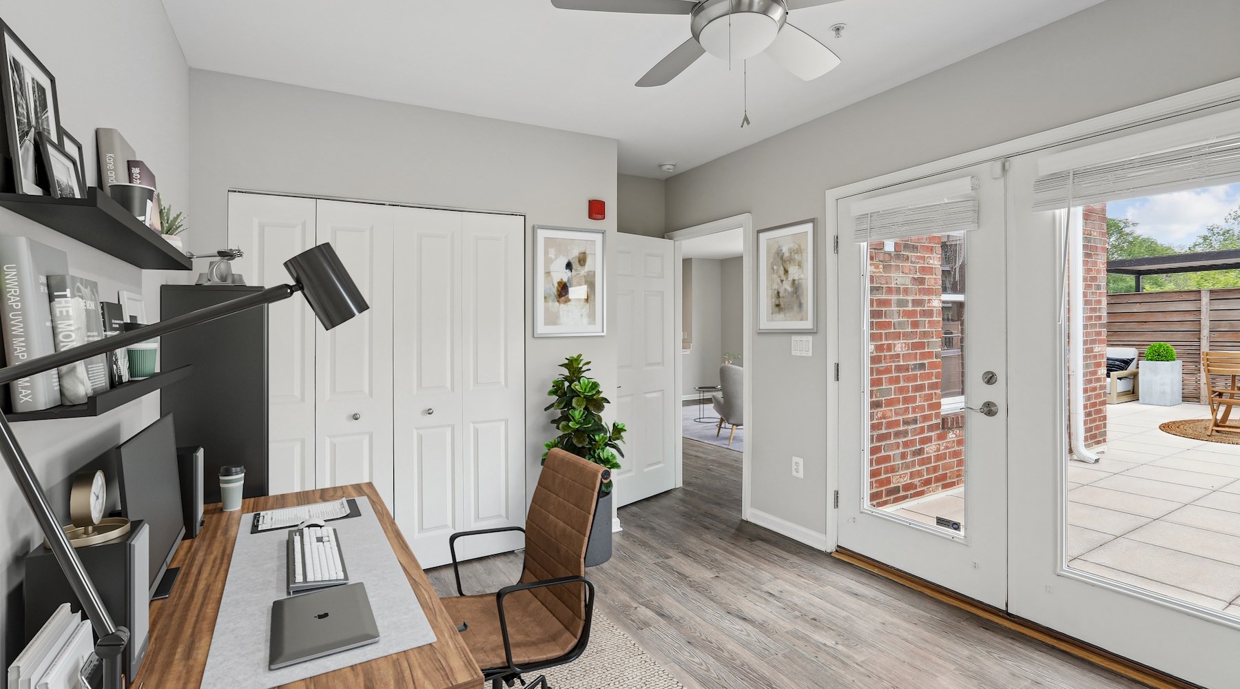 a room with a desk and large windows